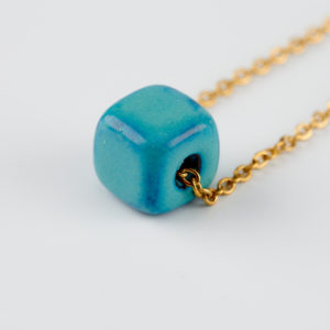 summery teal necklace in gold ceramic cube
